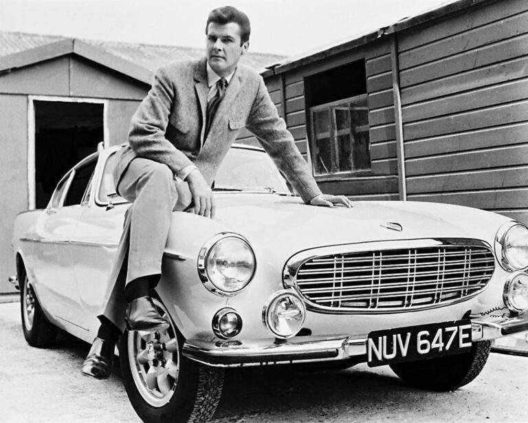 Roger Moore posing next to the p1800s from The Saint.